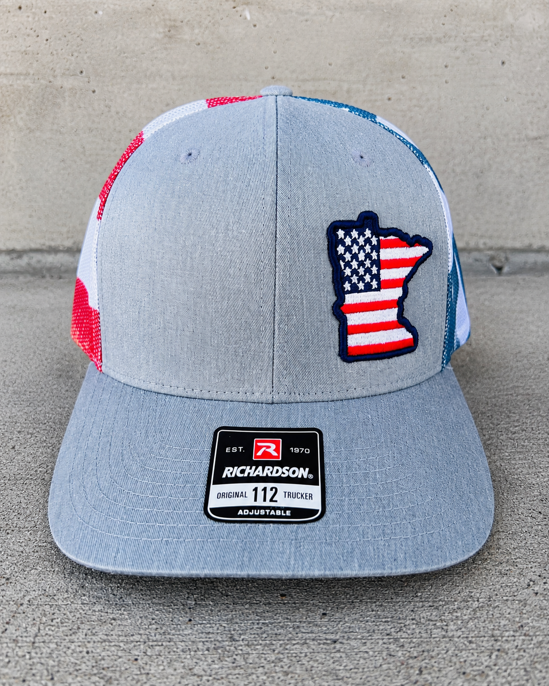 Finished custom embroidered trucker hat with Minnesota patch by TTN Custom Apparel